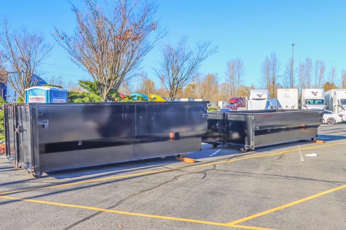 Professional dumpster rental service with roll-off container on residential driveway in Fruitland